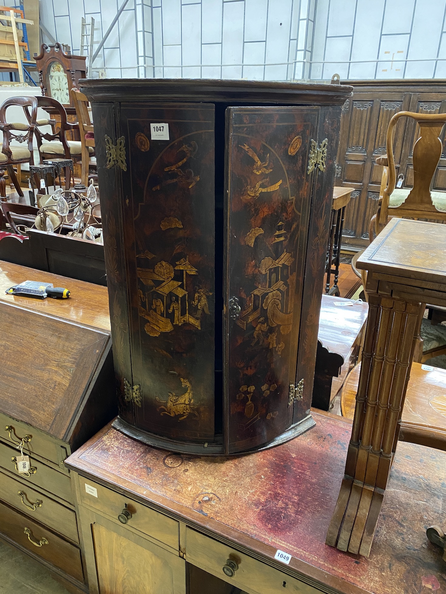 An 18th century chinoiserie lacquer bow front hanging corner cupboard, width 60cm, depth 40cm, height 92cm